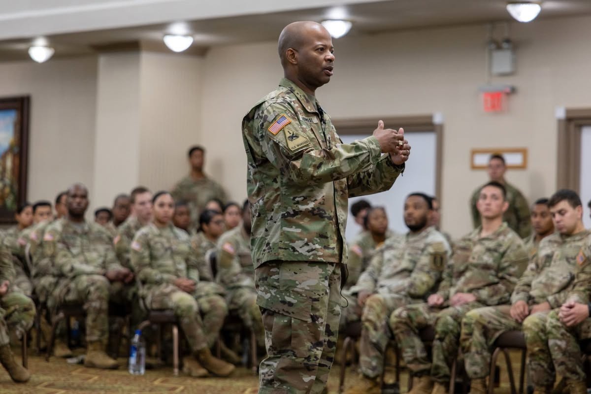 image of a leader speaking in front of a group of soldiers
